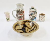 Five pieces of studio pottery to include a Colin Kellam jug with fish decoration on speckled cream