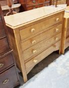 Early 20th century pale oak chest of four long drawers with turned wooden handles and raised on