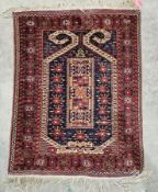 Eastern wool prayer rug with midnight blue field and rectangular totem of two guls, flowerhead