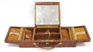 Early 20th century crocodile skin covered travelling jewellery case, the hinged central lid