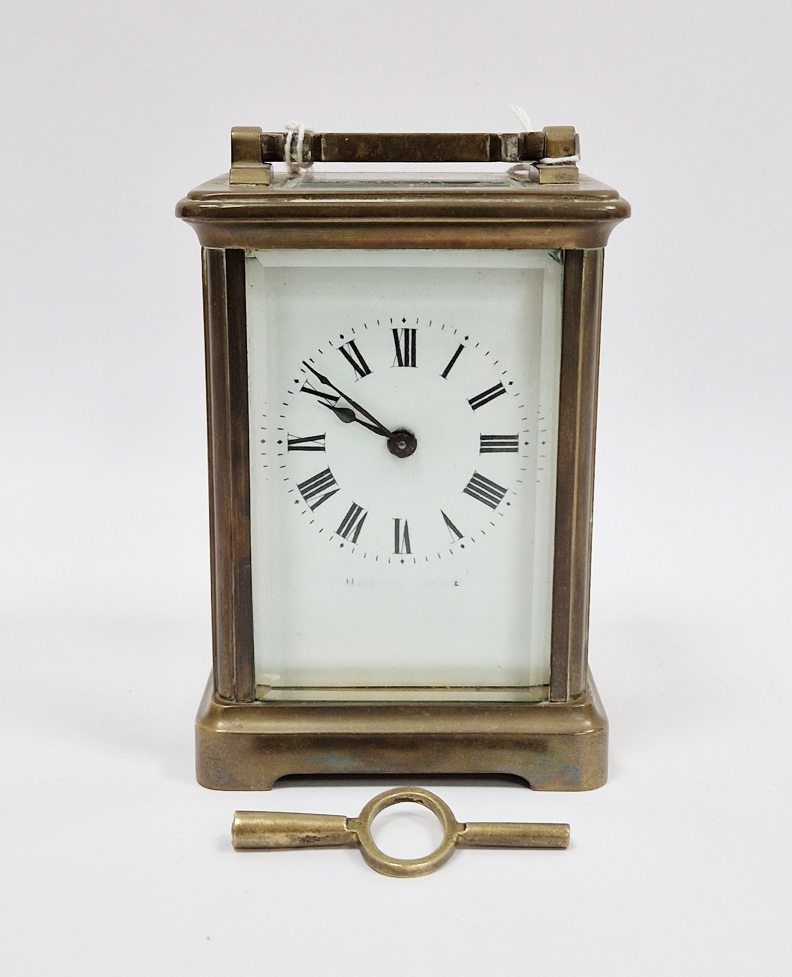 French gilt brass cased carriage clock, with bevelled edge glass panels, the white enamel face