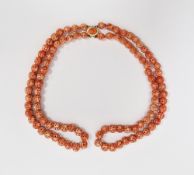 Coral double-strand bead necklace, comprising approximately ninety-nine carved beads of uniform size
