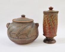 A large studio pottery lidded casserole with pale pink and blue hue glazed resist decoration on