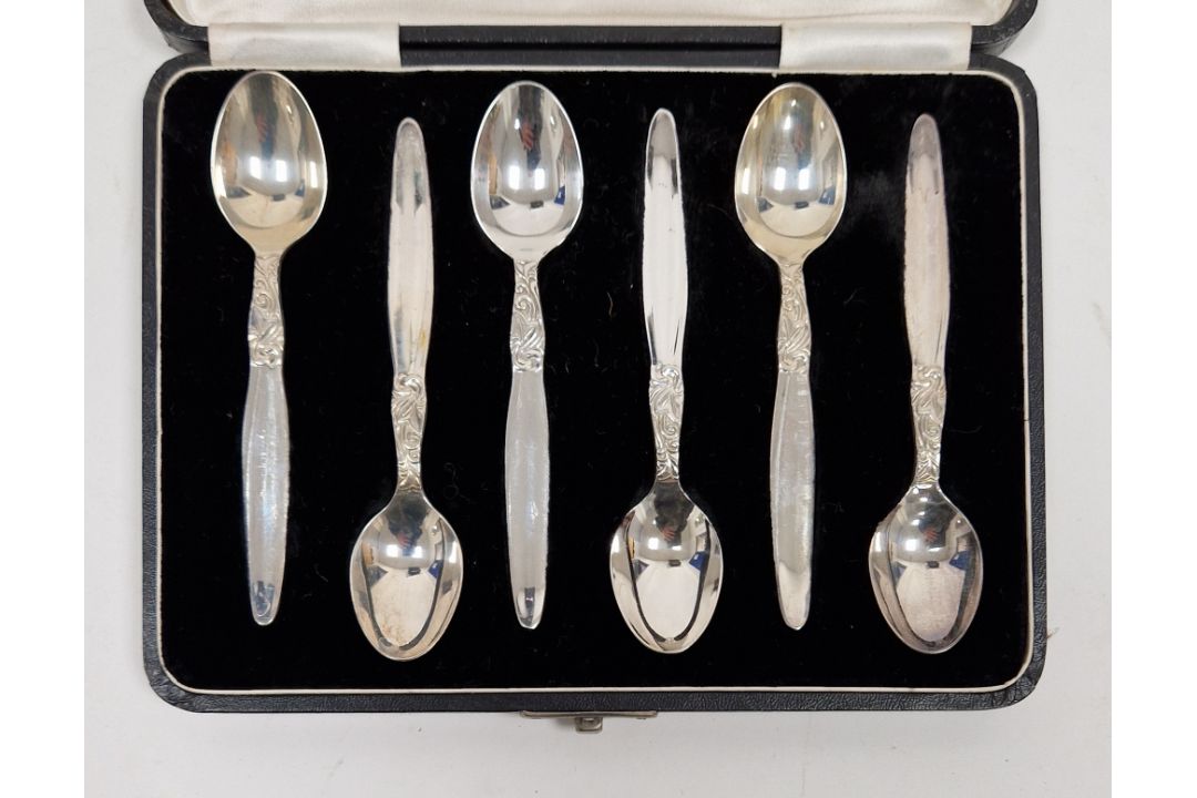 Set of six Indian white metal teaspoons, each stamped silver to underside, the handles with engraved