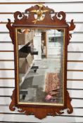 Mahogany and parcel-gilt fretwork carved hanging wall mirror in the George III manner, with ho-ho