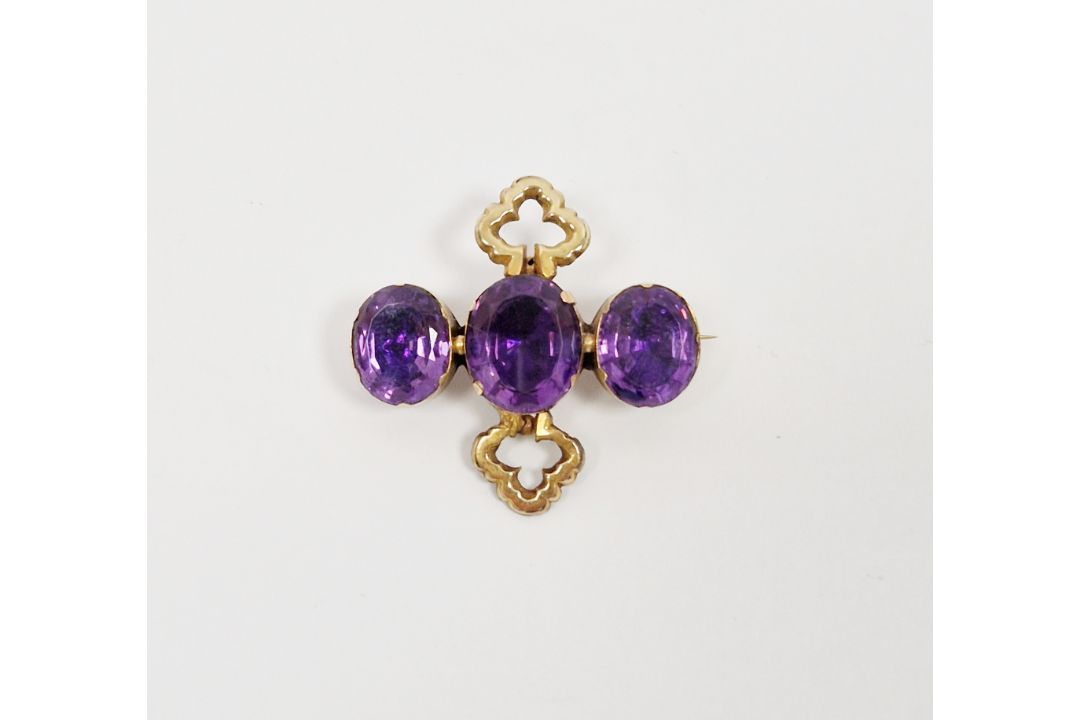 19th century amethyst brooch, composed of three oval mixed cut amethysts in a yellow metal claw