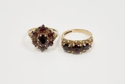 9ct yellow gold garnet cluster ring, claw set comprising a central oval mixed cut garnet