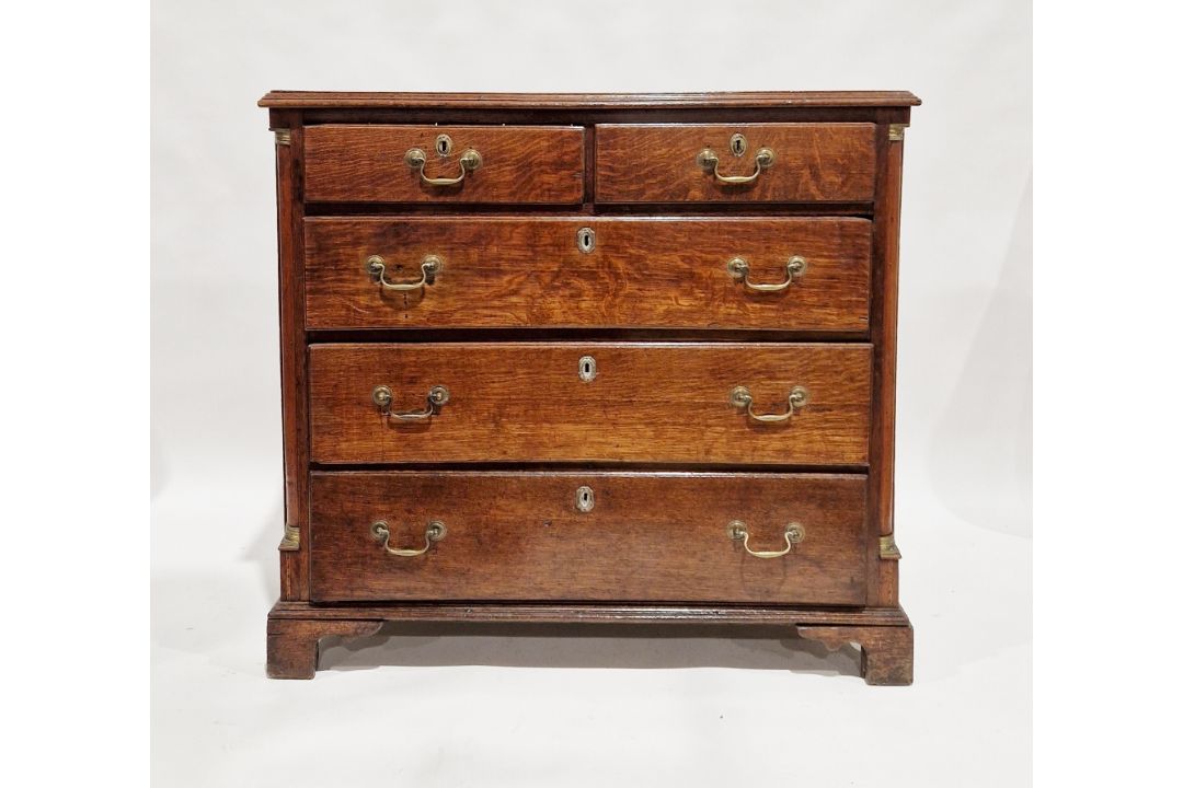 George III oak chest of two short over three long graduating drawers, the top with moulded edge