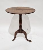 George III oak tilt-top side table, the circular top raised on a turned baluster support and three