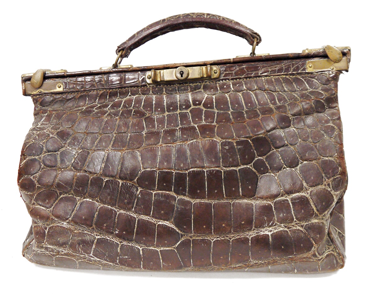 Late 19th/early 20th century crocodile skin gladstone bag with brass fittings and mustard coloured