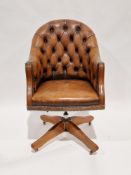 Victorian-style brown leather buttonback swivel office/library chair, raised on a wooden base with