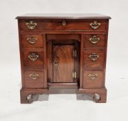 Small 18th century mahogany kneehole desk, the top with moulded ogee edge above an arrangement of