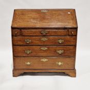 George III oak bureau, the sloping fall front opening to a fitted interior, with three drawers