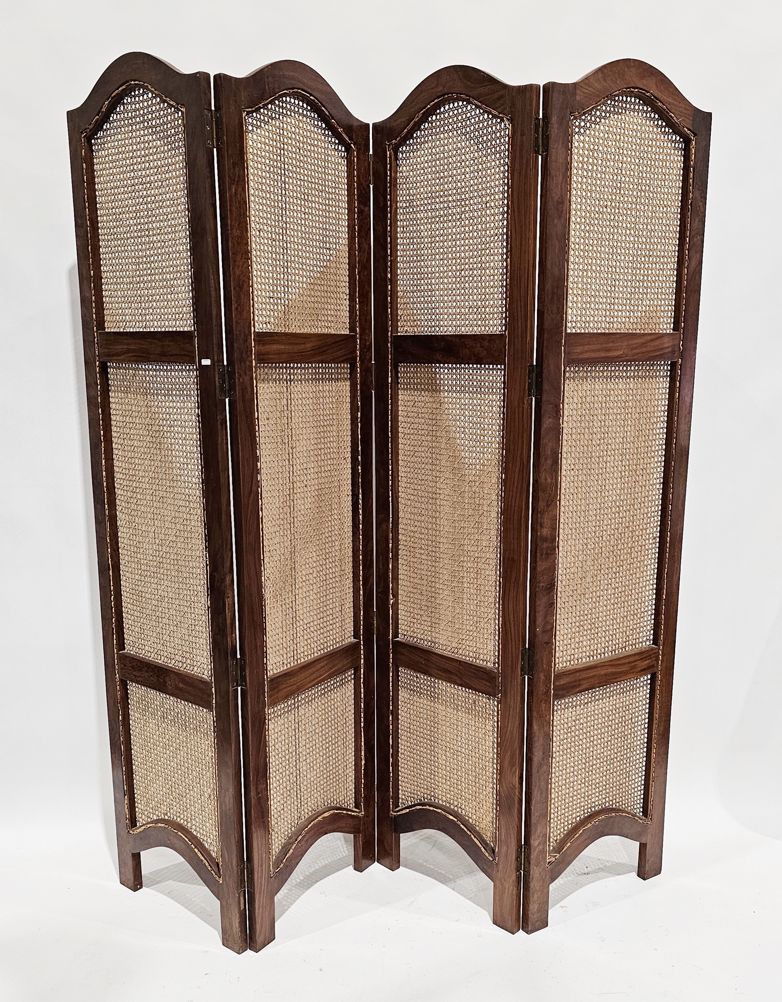 Hardwood framed four section folding dressing screen with arched top and bergere panels, each