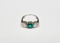 Early 20th century emerald and diamond white metal ring, the octagonal step cut emerald measuring