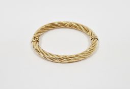 9k yellow gold hinged bangle of twisted design, stamped 375, approximately 6.5cm wide and 11.2