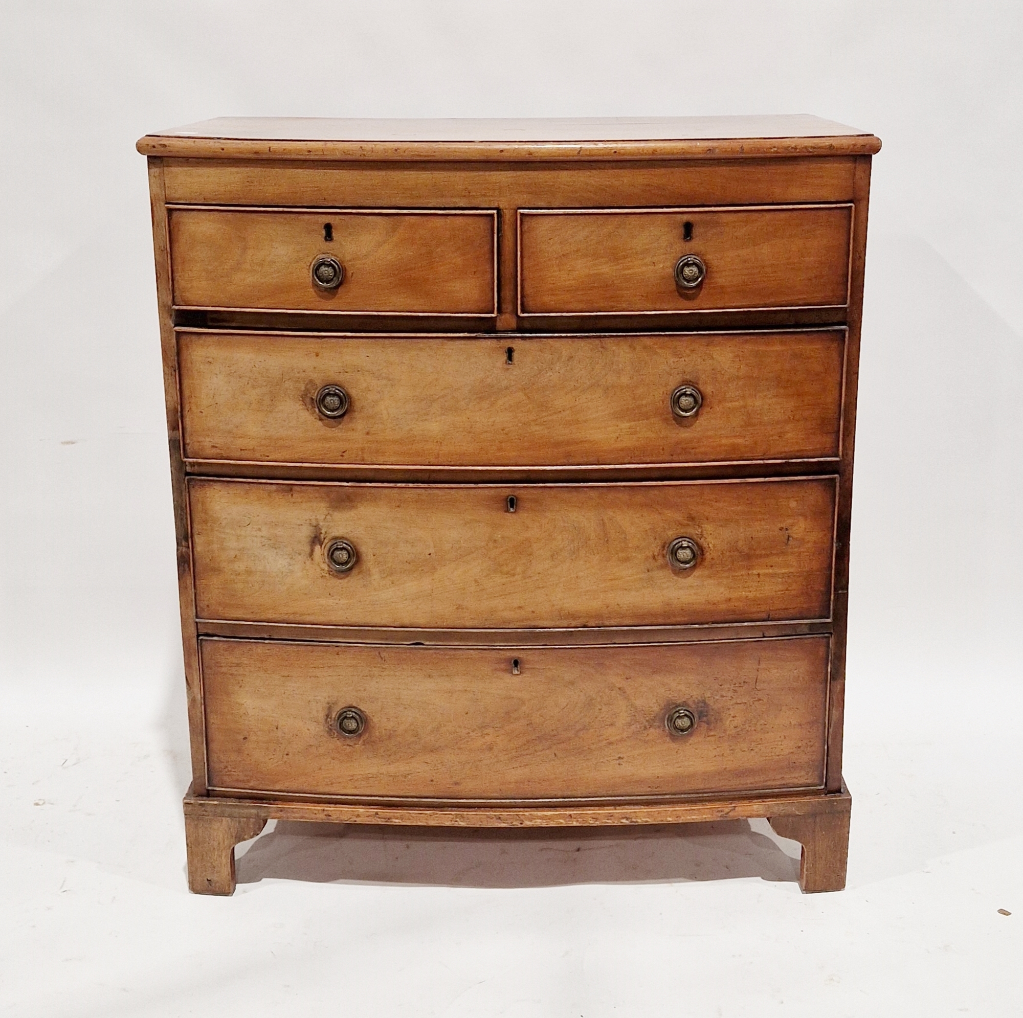 Early 19th century mahogany bowfronted chest of two short over three long graduating drawers, the
