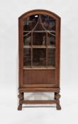 Early 20th century display cabinet with arched top, the single glazed door opening to three shelves,