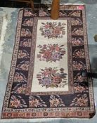 Eastern cream ground rug with three central floral motifs, multiple geometric, floral and stylised