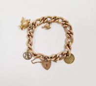 Rose gold-plated curb link bracelet with padlock clasp, two gold marked charms and two further