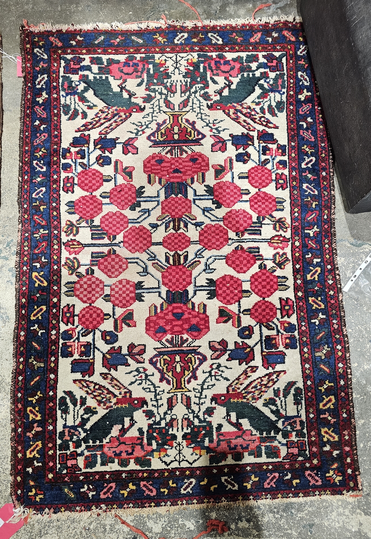 Eastern cream ground rug, the central field with floral pattern and stylised birds, multiple