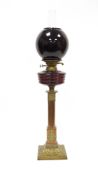 Victorian copper and brass Corinthian column oil lamp comprising a globular red glass shade,