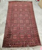 Afghan-style Eastern wool rug, having red ground and six rows of three stepped guls, geometric