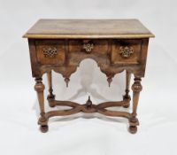 William and Mary-style walnut lowboy, the top with thumbnail moulded edge, above an arrangement of