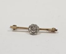 Gold and diamond cluster bar brooch, the centre stone approx 1/3ct and having surround of nine