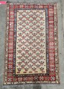 Eastern wool rug with allover stylised flowers to the cream field, red and blue geometric borders,