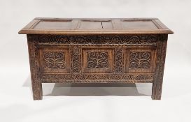 18th/19th century oak coffer, the hinged three-panel lid opening to an empty space, the three-