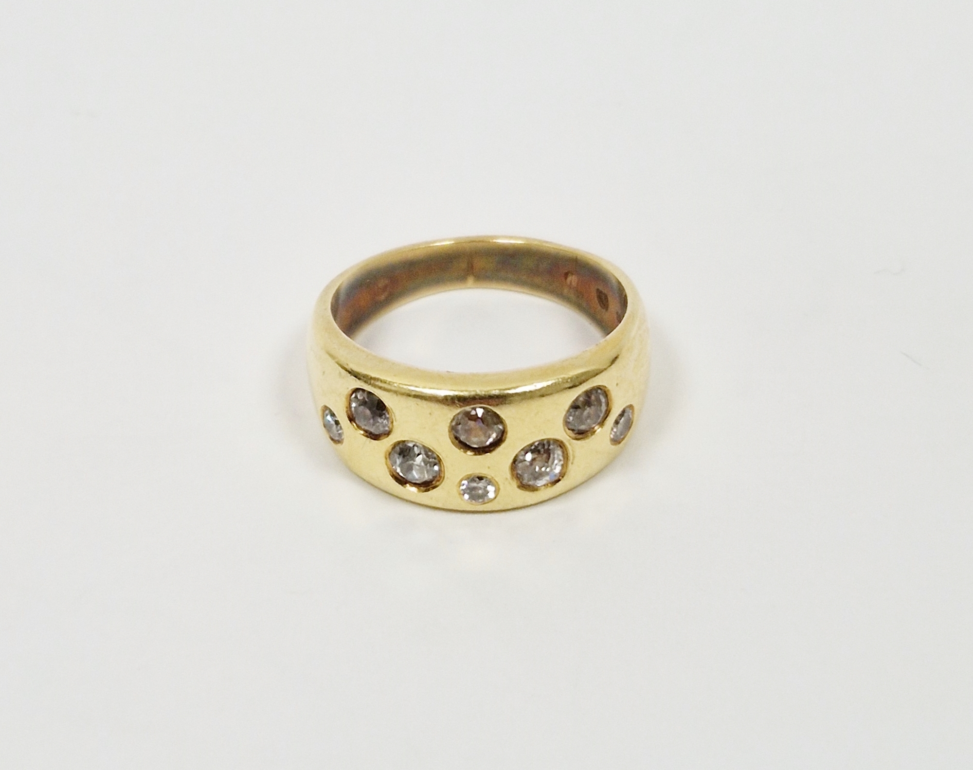 18K gold and diamond ring, the tapering band set with eight old cut variously sized diamonds in
