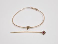 Yellow-metal ruby and diamond stick pin, the square head set with a central mixed cut ruby flanked
