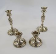 Pair of 1920's silver candlesticks, each with waisted sconce, panel tapering column on circular foot