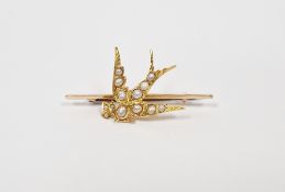 Antique gold-coloured metal and pearl bird brooch, the bird set with split pearls and carrying