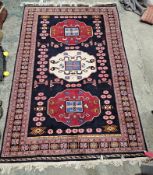 Large eastern midnight blue ground rug with three central geometric medallions, multiple geometric