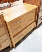 Modern wooden chest of three long graduating drawers with contemporary long silvered handles, 84cm