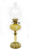 Late 19th / early 20th century brass oil lamp, with opaque globular etched glass shade depicting