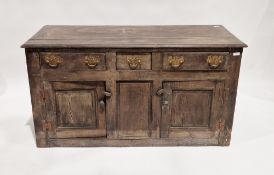 18th / early 19th century oak dresser base, the top with thumb-nail moulded edge, three drawers with