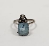 White metal and pale blue stone solitaire ring, the cushion shape stone topped by a trio of three