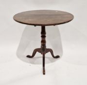 George III oak tilt-top supper table, the circular top raised on a turned double baluster support