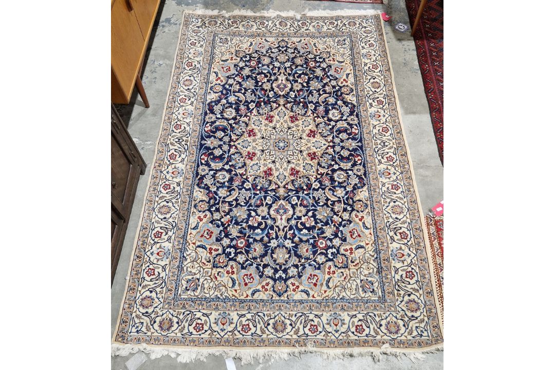 Large Persian midnight blue ground rug with central cream floral medallion on floral field, floral - Image 1 of 22