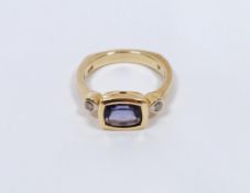 14K gold, blue and white stone dress ring, the rectangular cut stone probably a sapphire flanked