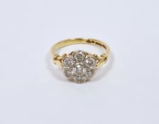 1920’s 18ct gold, platinum and diamond cluster ring set seven stones in flowerhead settings (size P)