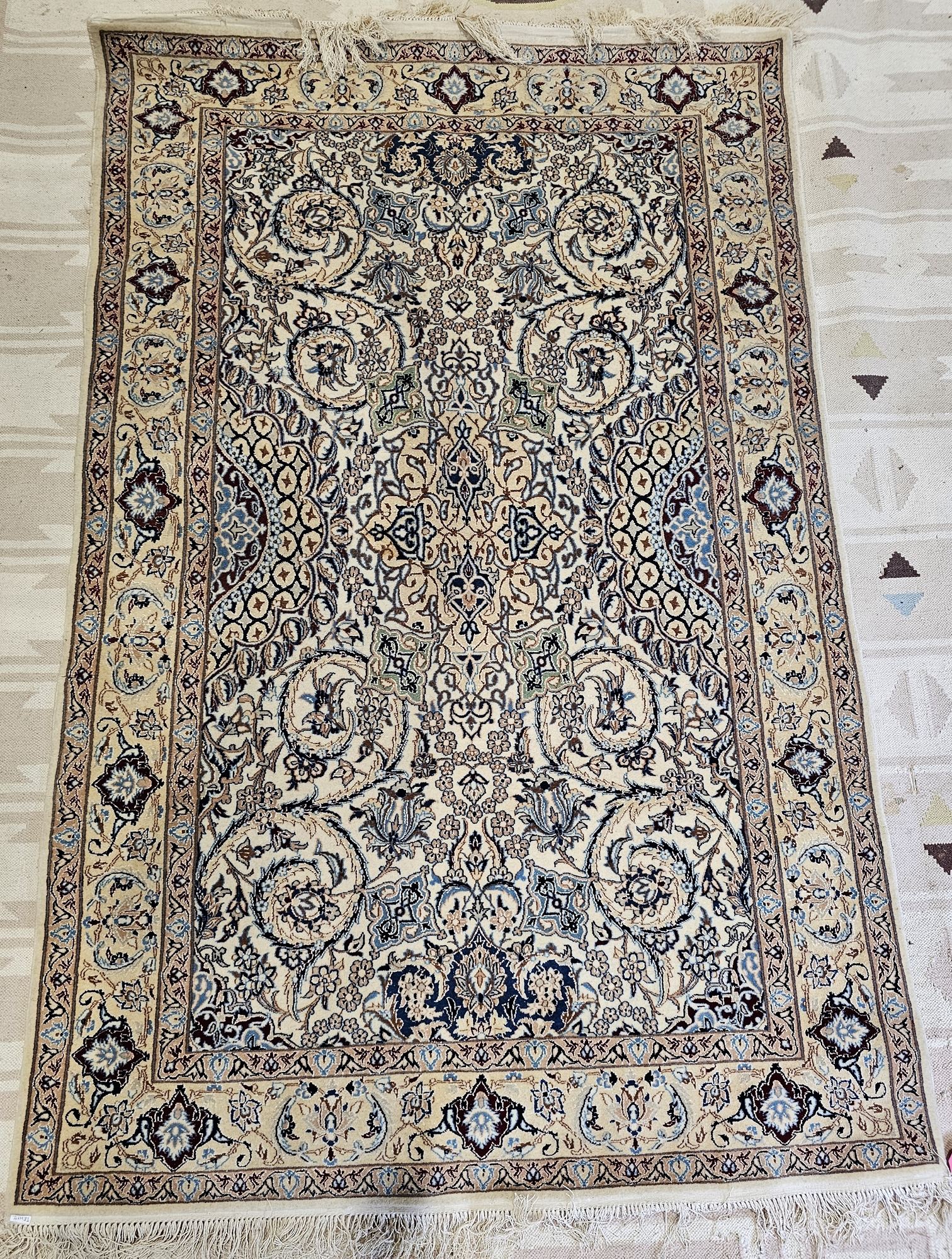 Persian ivory ground rug with central floral medallion on floral field, multiple floral and herati