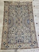 Persian ivory ground rug with central floral medallion on floral field, multiple floral and herati