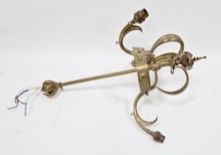 In the manner of W.A.S. Benson, an Arts and Crafts brass three branch ceiling light fitting or