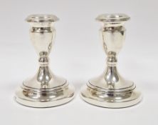 Pair of silver candlesticks, Birmingham 1979, maker's mark ESC, with plain urn-shaped sconces and