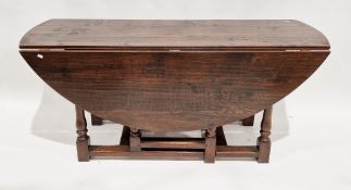 18th century oak circular gate-leg table raised on turned and block supports united by rectangular