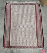 Cream ground kilim with allover stylised pink and green flowers and having floral and chevron